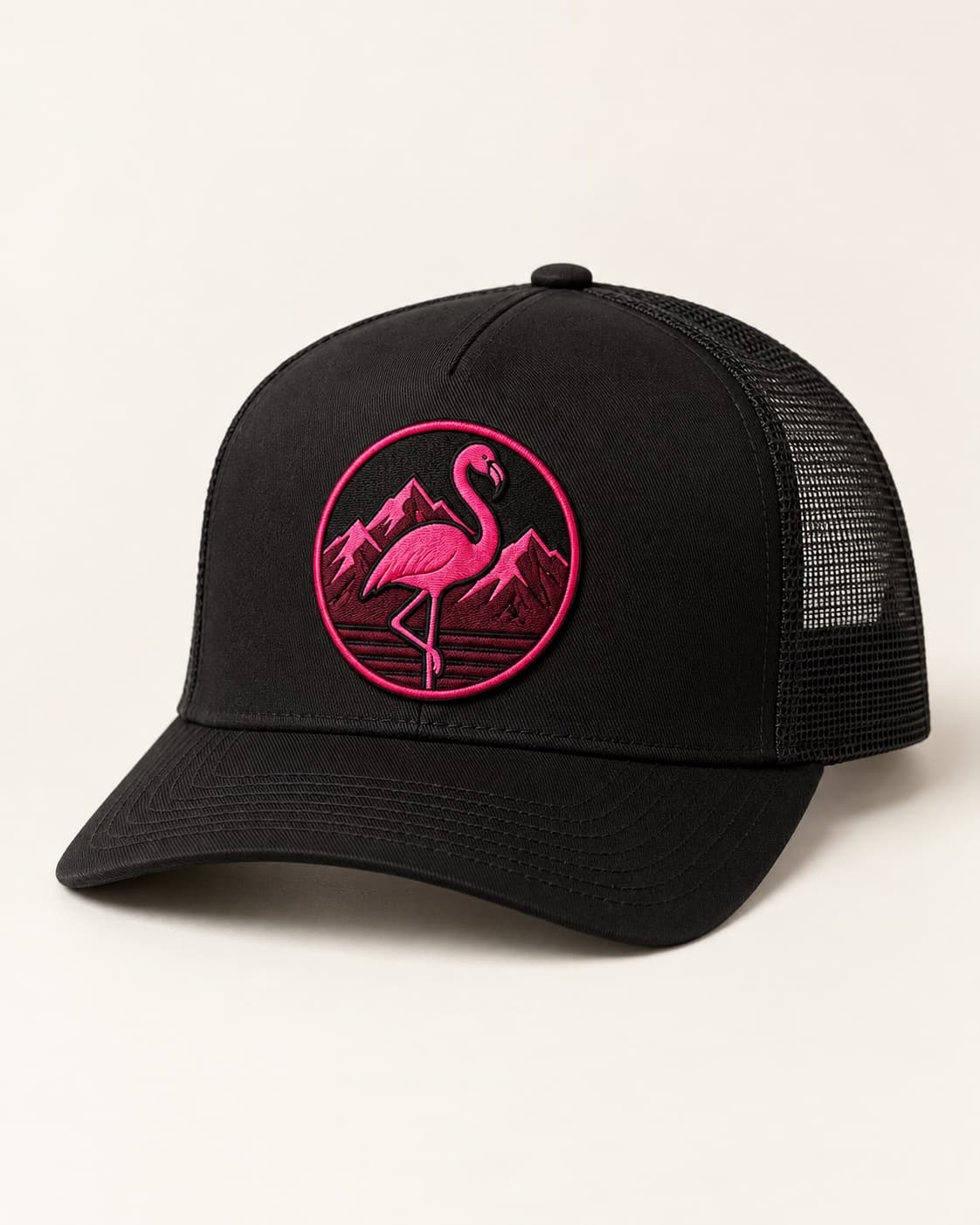 Black trucker hat with an embroidered pink flamingo mountain patch